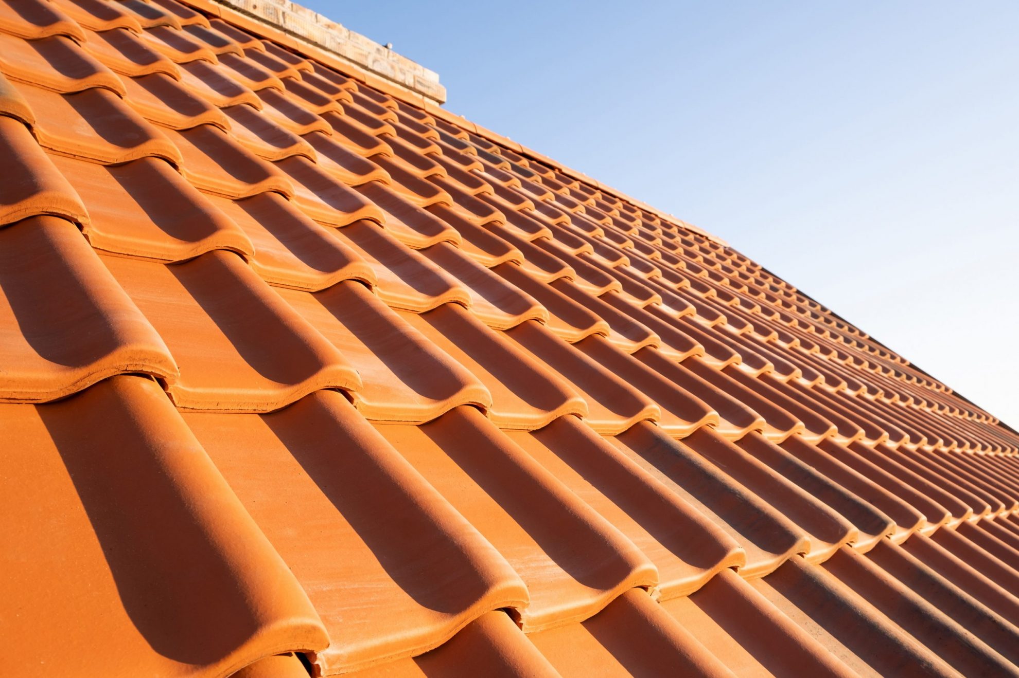 Roof with red tiles illustrates blog "4 Tips To Extend the Lifespan of Your Roof"