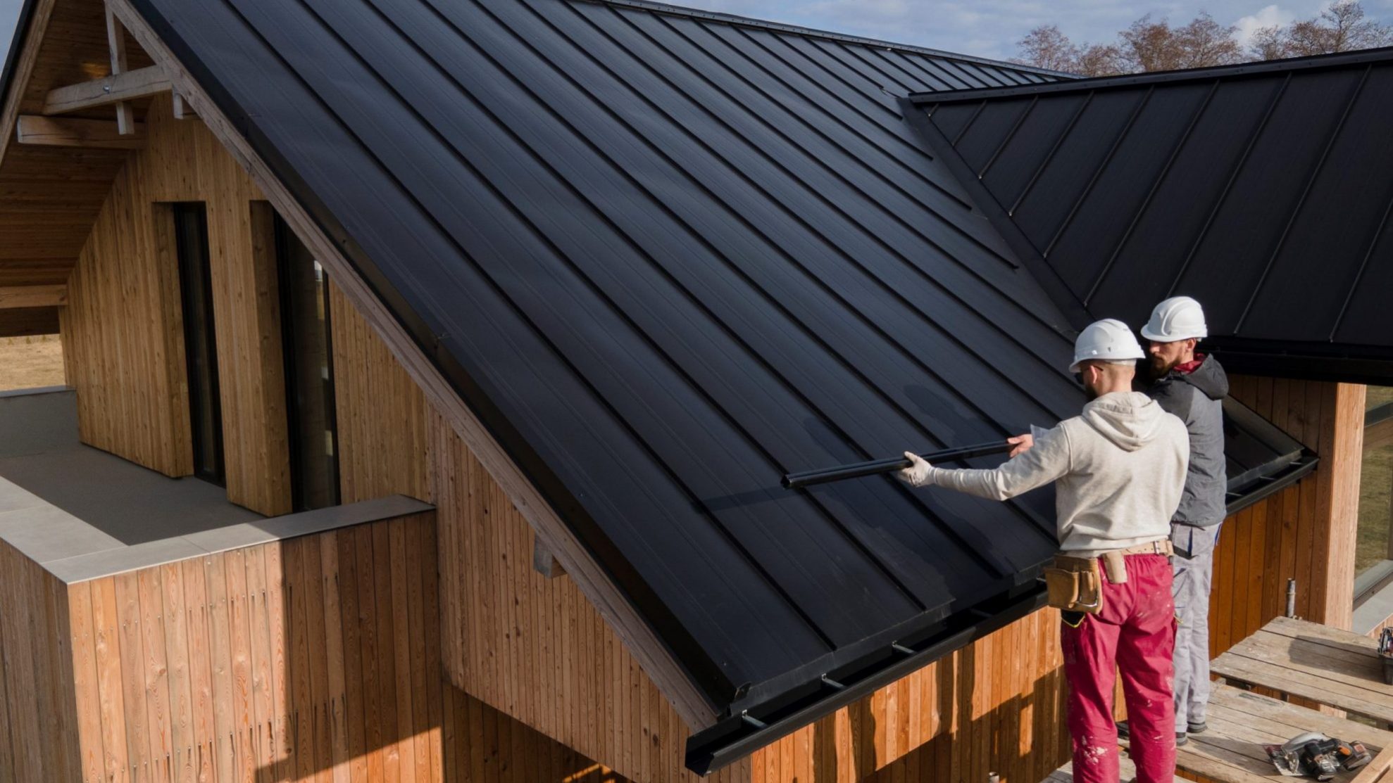 Photo of roofing contractors illustrates blog "Basic Roofing Terms You Need To Know"