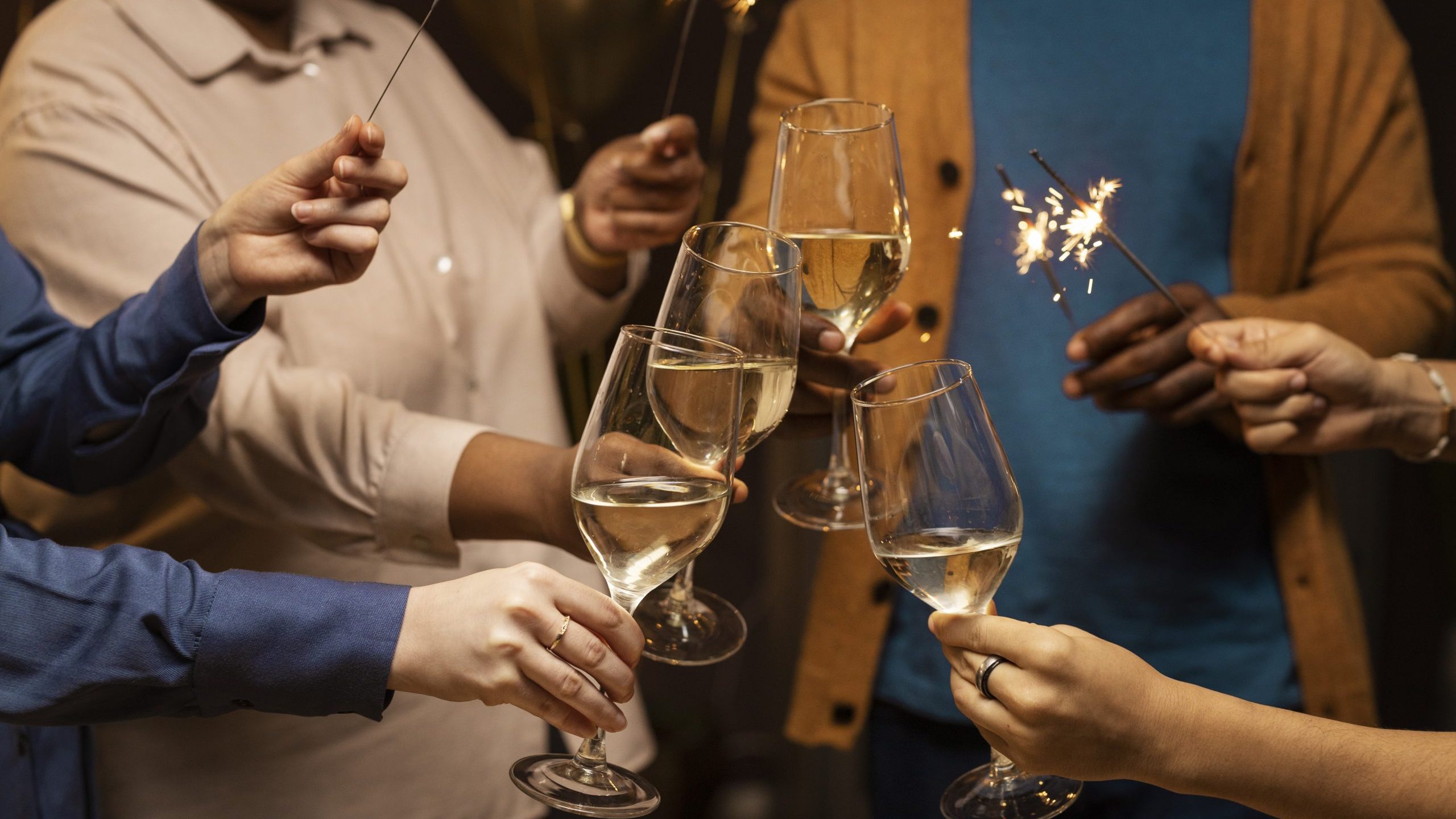 Four people toasting to the new year illustrate blog "5 New Year’s Resolutions To Keep Your Roof in Top Shape"