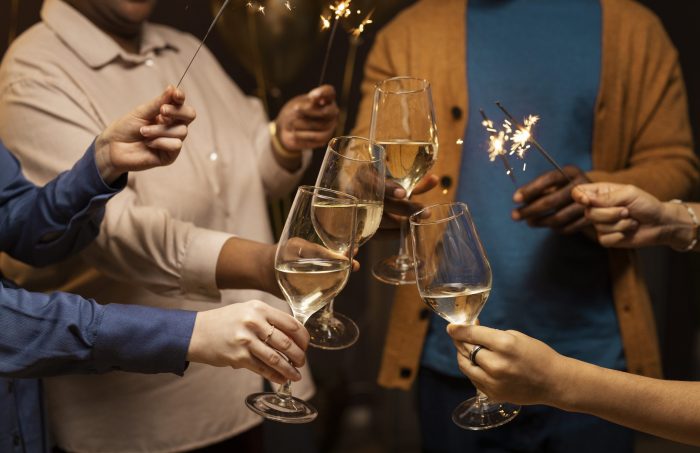 Four people toasting to the new year illustrate blog "5 New Year’s Resolutions To Keep Your Roof in Top Shape"