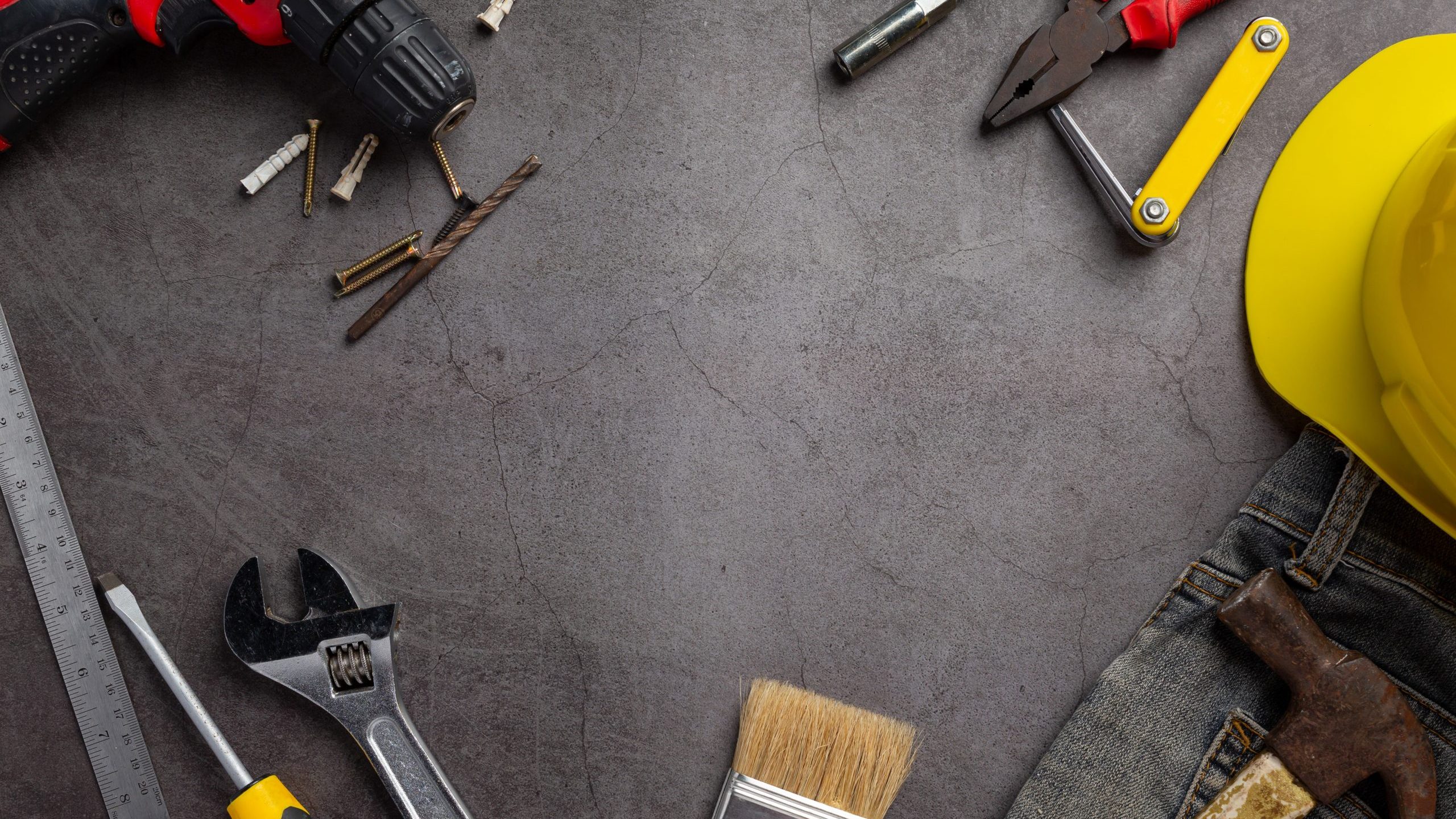 Composition with tools and hard hat illustrates blog "Can You Repair Just Part of a Roof?"