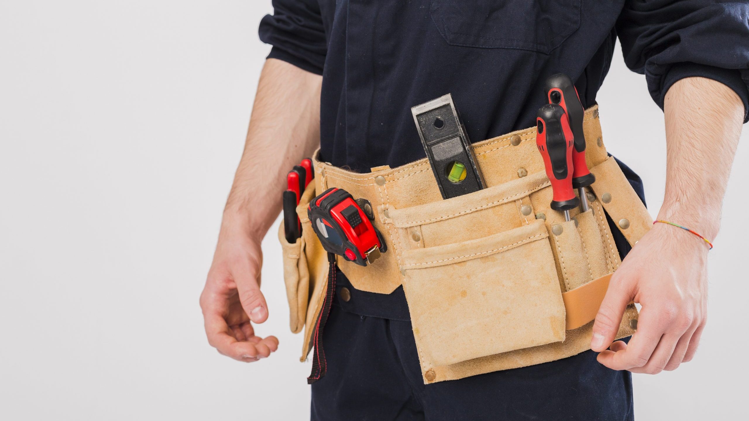 Handyman with tool belt illustrates blog "Can You Repair Your Roof Yourself?"