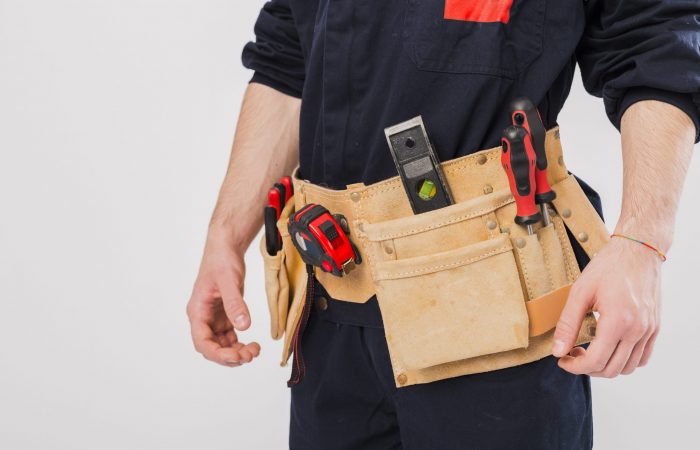 Handyman with tool belt illustrates blog "Can You Repair Your Roof Yourself?"