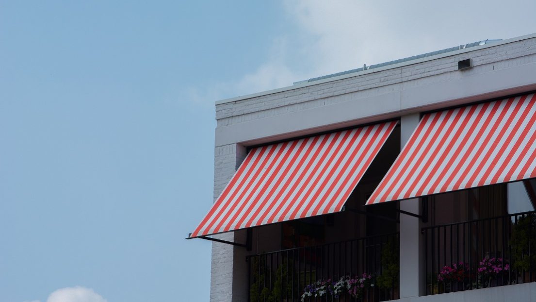 commercial-roof-eyeem Commercial roof with red-and-white striped awning.