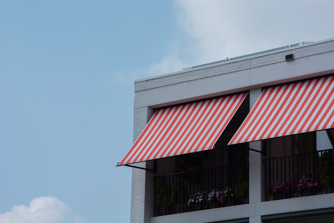 Commercial roof with red-and-white striped awning.