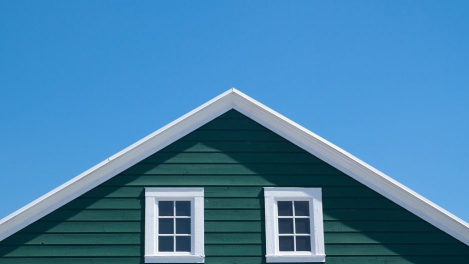 Green house and white roof with blue sky in sunny day Roof against spring sky.