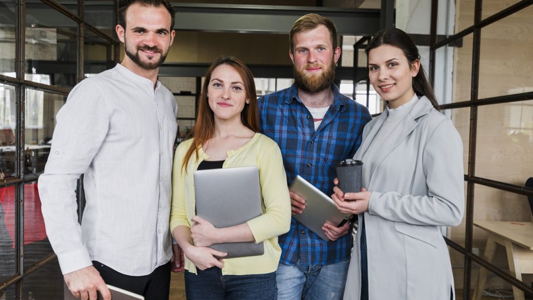 business-owners-casual-freepik Business owners posing for photo illustrate blog "Addressing Common Commercial Roofing Challenges and Solutions"