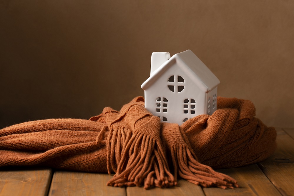 Toy house with a scarf wrapped around it illustrates blog