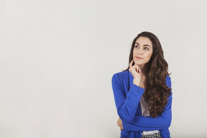 Woman in wondering attitude illustrates blog "When to Schedule a Professional Roof Inspection"