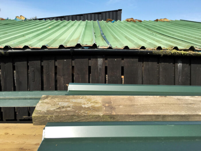 Roof decking replacement showing sagging roofline