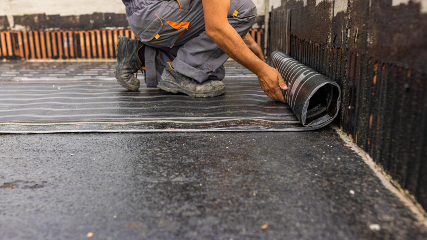 worker-laying-vapor-barrier-roof-bituminous-membrane-be-welded-with-flame Roofing underlayment installation on California home