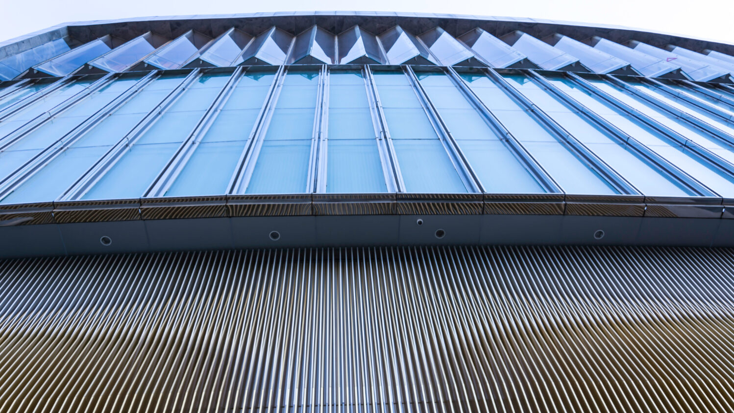 Contractor applying reflective coating on an energy-efficient roof in California