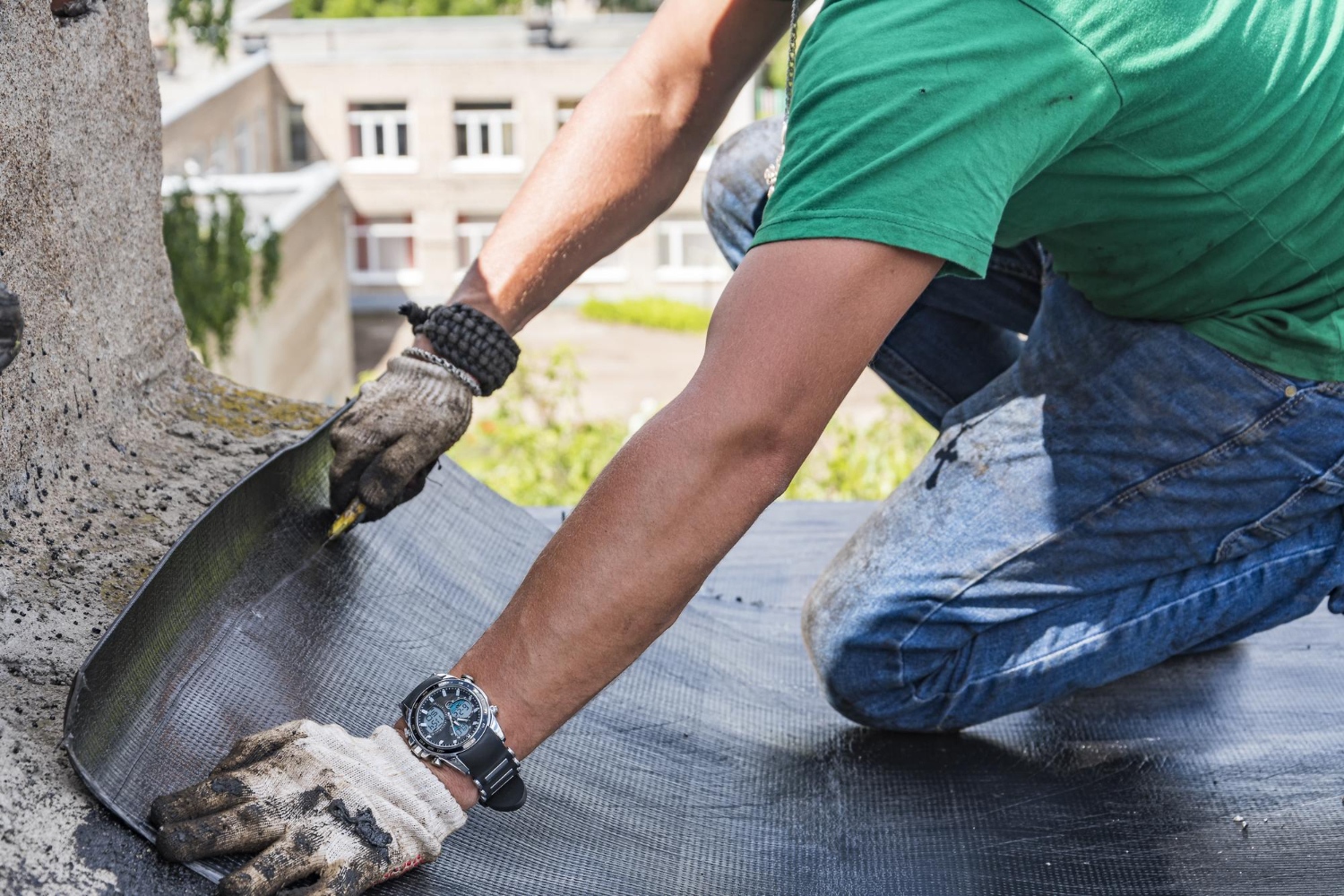 Contractor applying foam adhesive on a California rooftop