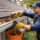 Professional performing gutter maintenance to prevent roof damage and leaks