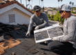 Roofing crew evaluating roof overlay vs reroofing options on a home