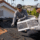 Roofing crew evaluating roof overlay vs reroofing options on a home